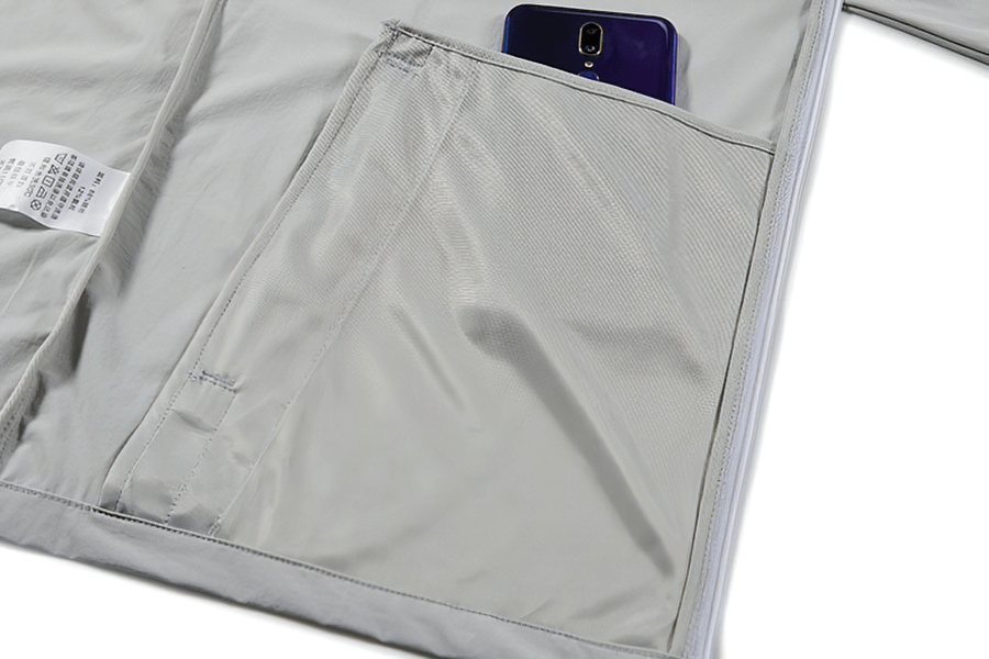 Interior pocket of a hiking sun-protective windproof men's jacket, featuring a mesh design and smartphone compartment.